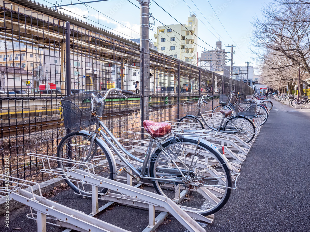 bicycles parked in the lot beside the train station in tokyo 