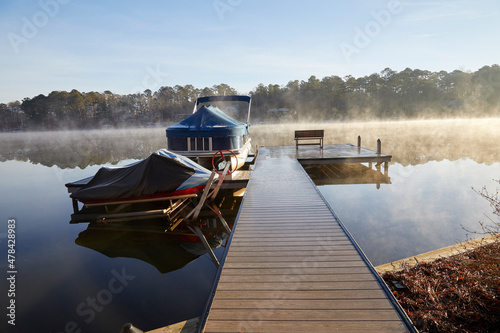 My boat dock on a beautiful morning with fog steaming from the lake