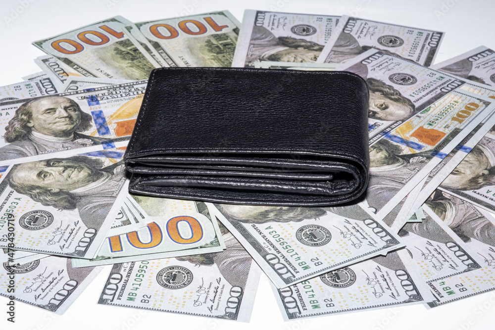 black leather wallet on money black leather wallet on money