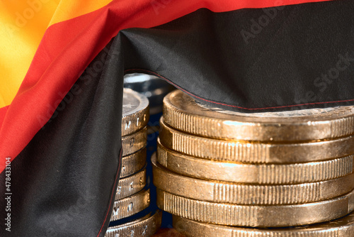 Flagge von Deutschland und Stapel Euro Münzen photo