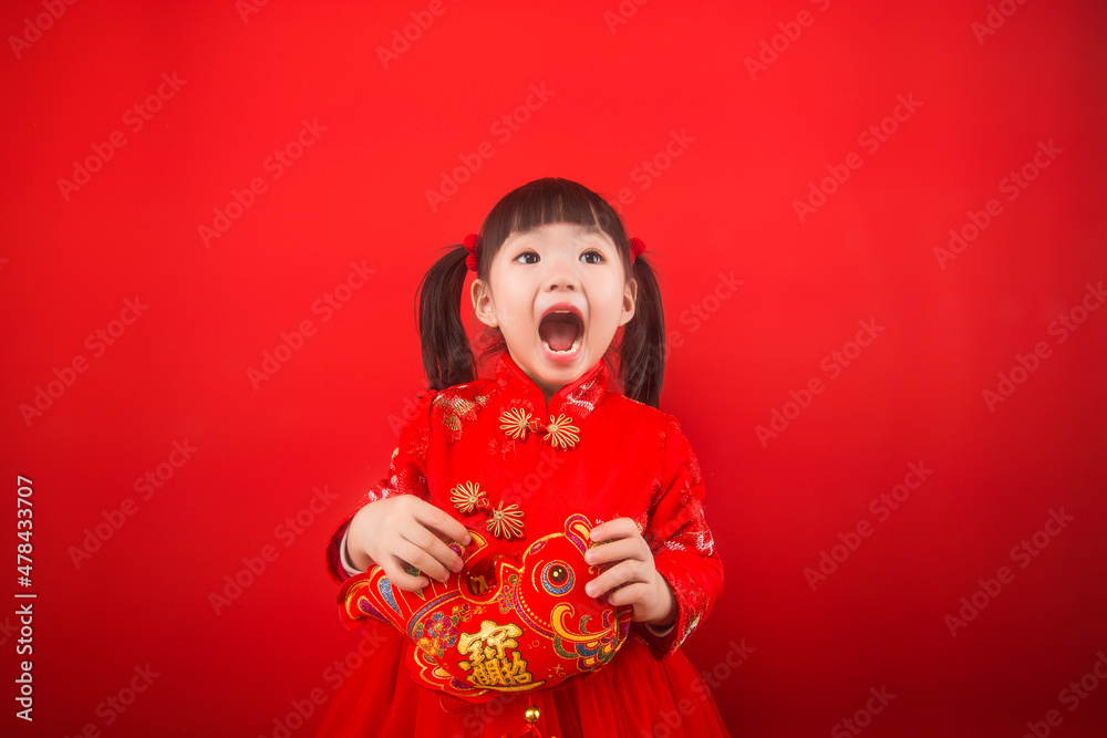 A girl celebrates Chinese New Year with a Chinese knot A girl celebrates Chinese New Year with a Chinese knot