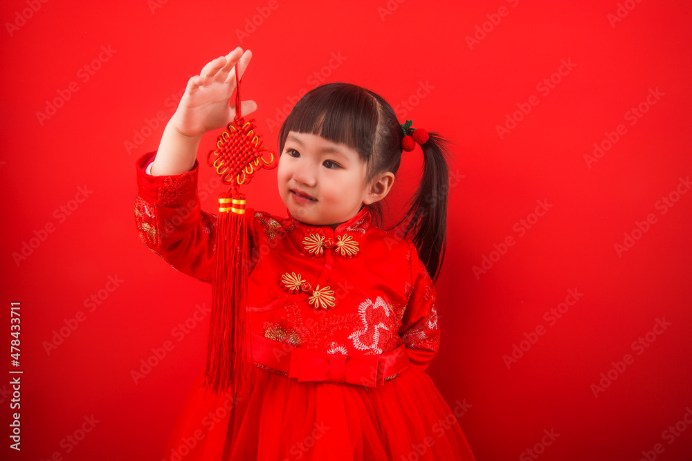 A girl celebrates Chinese New Year with a Chinese knot A girl celebrates Chinese New Year with a Chinese knot