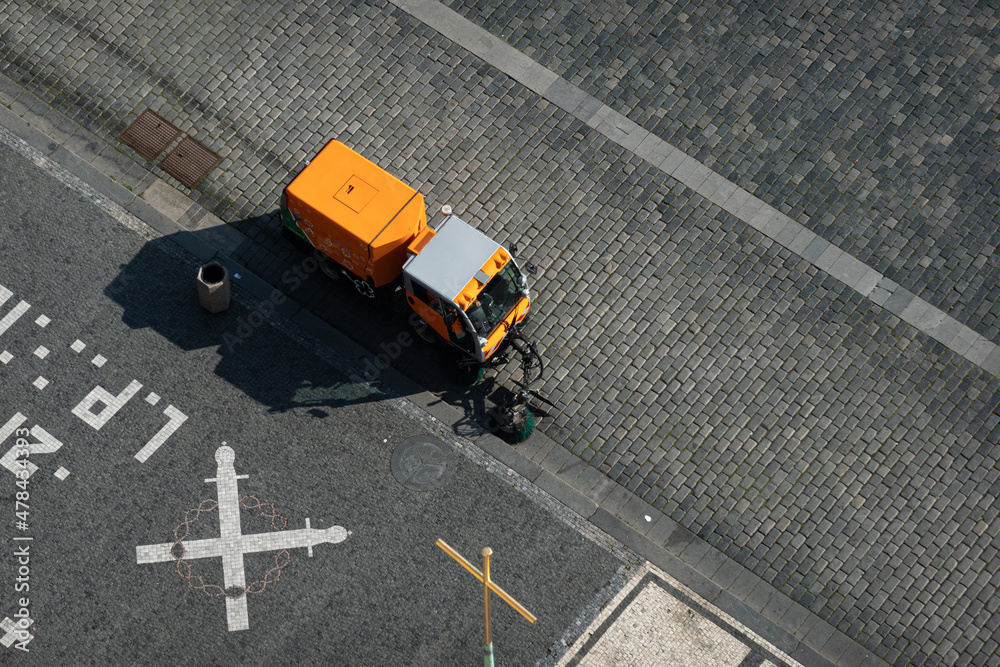 Travel during COVID-19 pandemic. Cleaning the streets and the old town square of Prague, Czech Republic. View from above of an electrical car used to mentain the cities clean. Travel during COVID-19 pandemic. Cleaning the streets and the old town square of Prague, Czech Republic. View from above of an electrical car used to mentain the cities clean.
