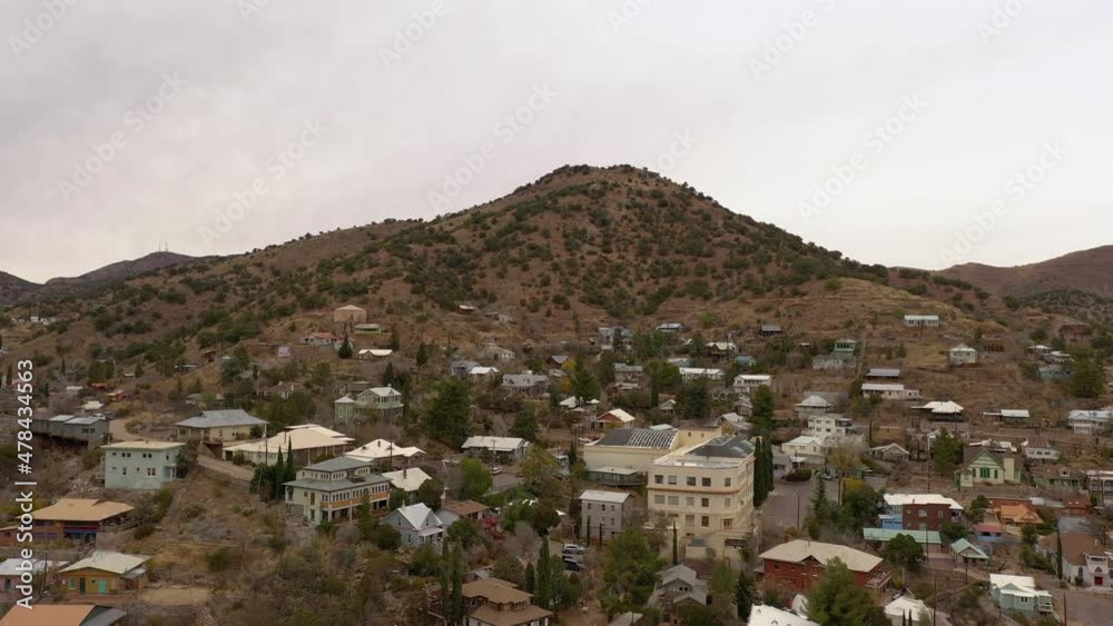 Drone ascending over old mining town Bisbee Arizona, daytime overcast sky Drone ascending over old mining town Bisbee Arizona, daytime overcast sky