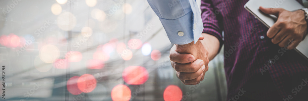 Two businessman shaking hands with business deals and congratulations on success, panorama image use for cover design. - obrazy, fototapety, plakaty 
