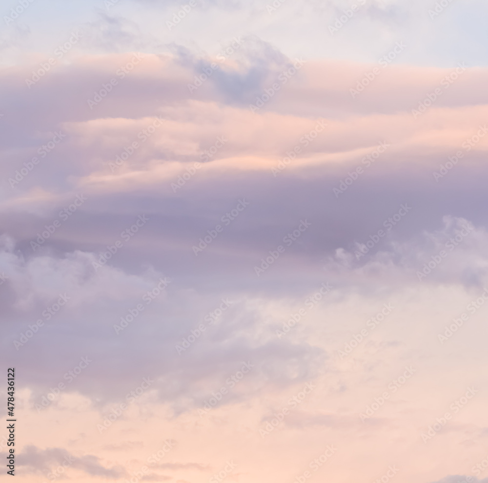Background of blue sky with white and pink clouds in sunset
