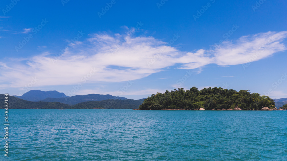 Island under blue sky in blue sea Island under blue sky in blue sea