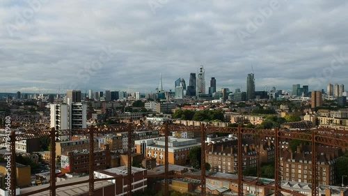 The cloudy East London skyline cityscape from Bethnal Green with Victorian gas holder metal frames in view. photo