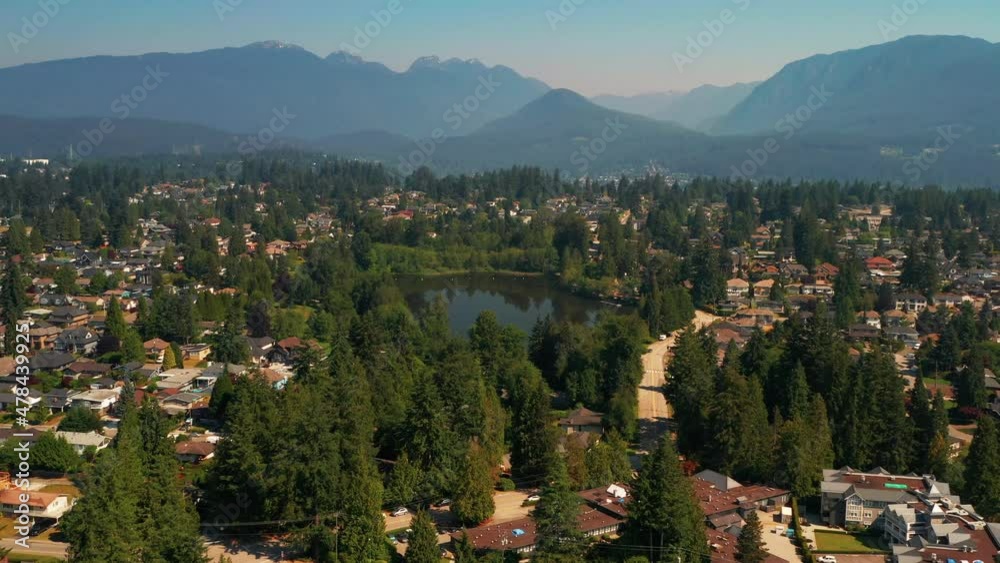 Scenic aerial view flying toward Como Lake Park in picturesque Coquitlam, Greater Vancouver. Scenic aerial view flying toward Como Lake Park in picturesque Coquitlam, Greater Vancouver.
