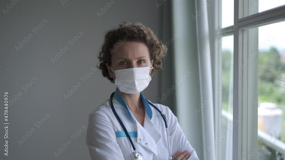 Portrait of female doctor seriously looking at the camera, solving medical issues, worrying about a global pandemic Portrait of female doctor seriously looking at the camera, solving medical issues, worrying about a global pandemic