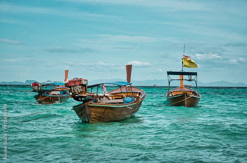 Thai traditional Long tail boats resting on the shores of the magical island Koh Lipe