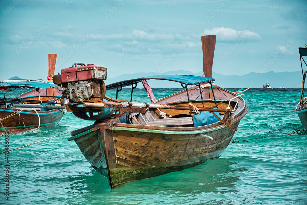 Thai traditional Long tail boats resting on the shores of the magical island Koh Lipe Thai traditional Long tail boats resting on the shores of the magical island Koh Lipe
