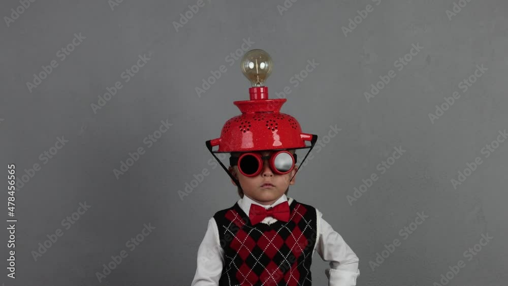 Funny child wearing handmade helmet with lightbulb. Slow motion