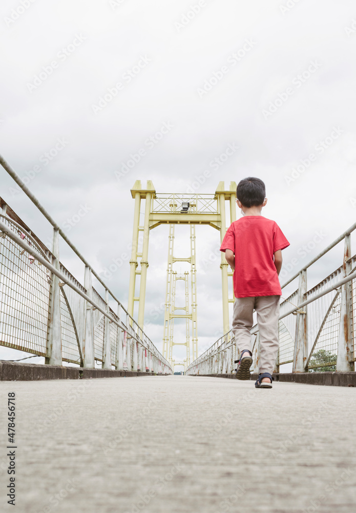 child with red t-shirt on the bridge child with red t-shirt on the bridge