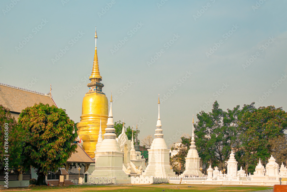 The yellow pagoda is in the group of white pagodas. The yellow pagoda is in the group of white pagodas.