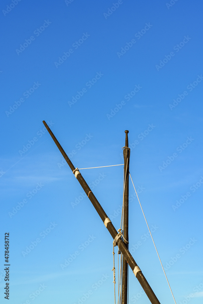 Close-up of the upper part of lateen rigging sailboat against the blue sky. Catarroja port, Albufera Natural Park, Valencia, Spain Close-up of the upper part of lateen rigging sailboat against the blue sky. Catarroja port, Albufera Natural Park, Valencia, Spain