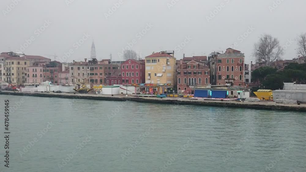 Venice, Italy - January 2022 - Traveling on the ferry that transports cars, along the Giudecca canal, among the splendid historic buildings of the lagoon city Venice, Italy - January 2022 - Traveling on the ferry that transports cars, along the Giudecca canal, among the splendid historic buildings of the lagoon city