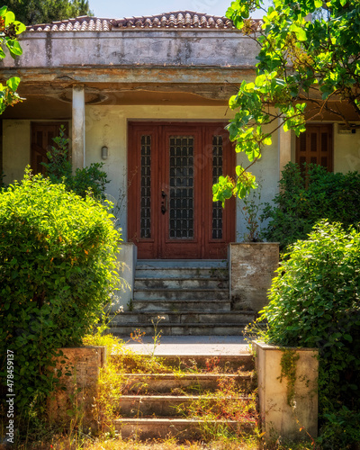 abandoned villa green garden and elegant facade, Athens, Greece