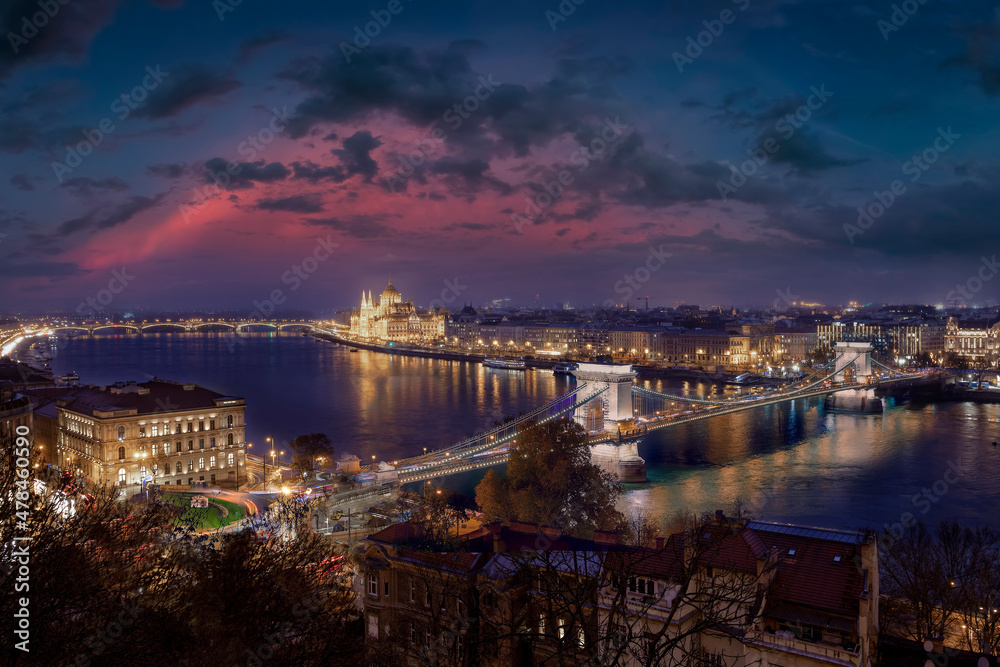 The illuminated Budapest skyline during dusk with the famous Chain Bridge along river Danube and the Parliament building, Hungary