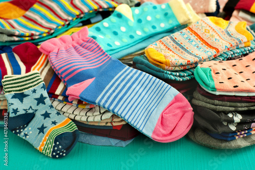 Colorful socks in a heap. Many different socks are stacked. Clothes in the form of socks for the cold seasons.