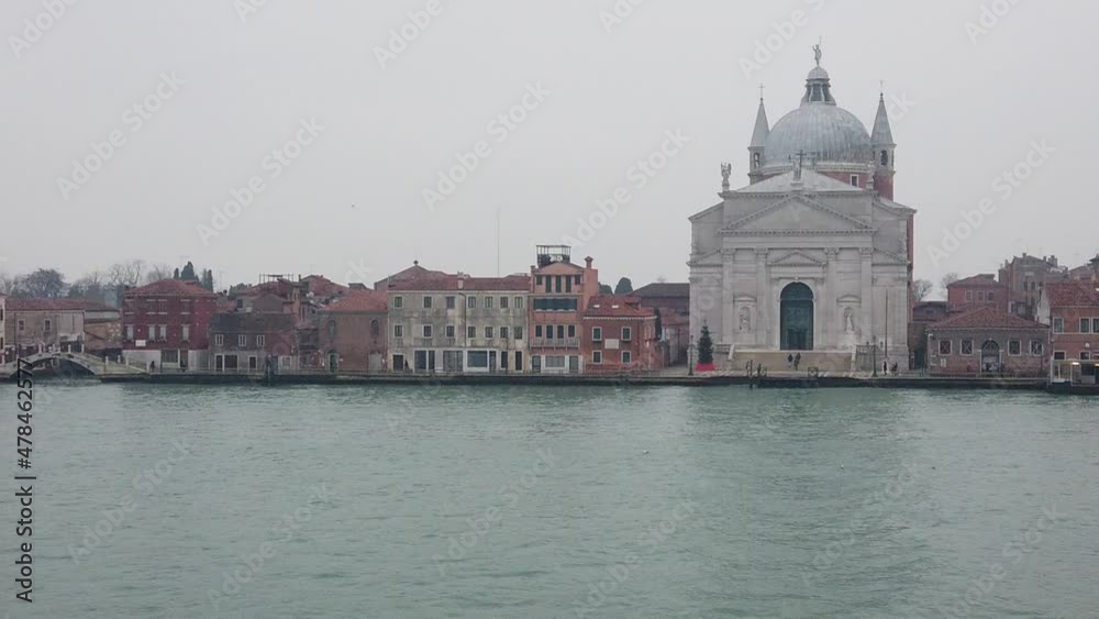 Venice, Italy - January 2022 - Traveling on the ferry that transports cars, along the Giudecca canal, among the splendid historic buildings of the lagoon city Venice, Italy - January 2022 - Traveling on the ferry that transports cars, along the Giudecca canal, among the splendid historic buildings of the lagoon city