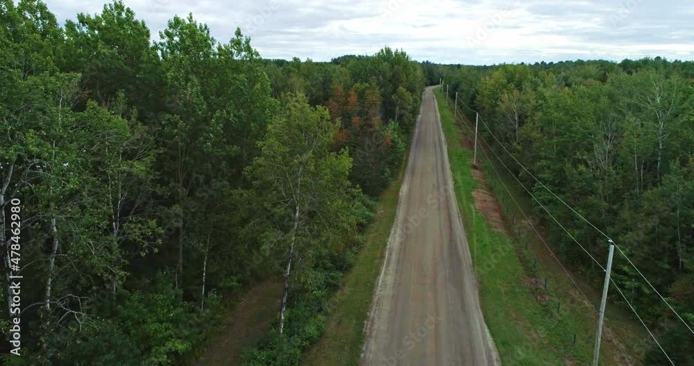 Aerial view moving forward over the dirt road leading to the entrance of the Batiscan river park Aerial view moving forward over the dirt road leading to the entrance of the Batiscan river park