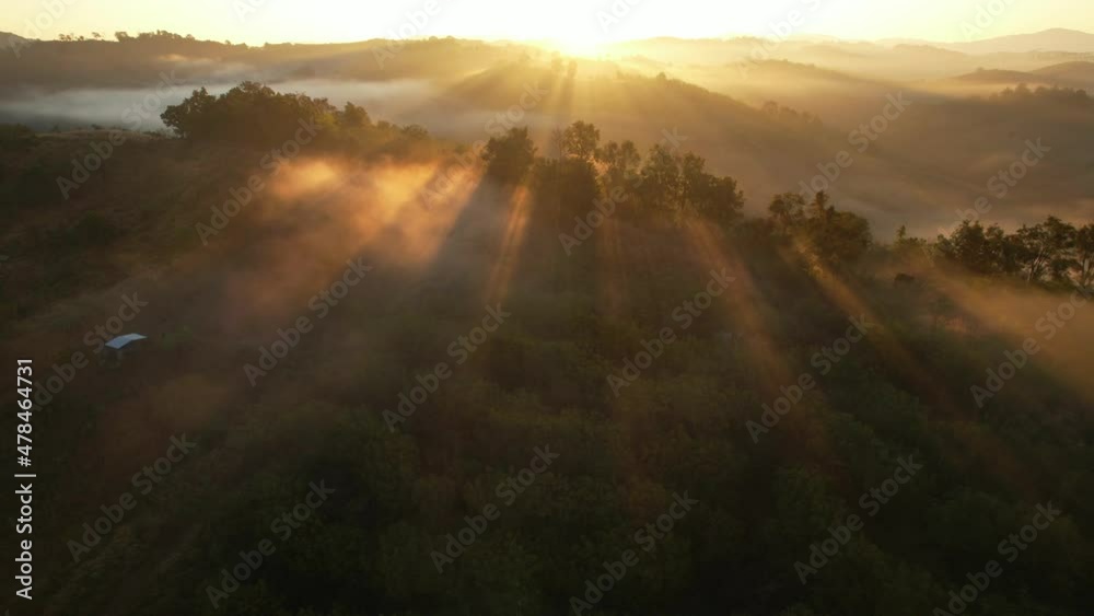 Aerial view of sunrise with fog above mountains. Golden hour and amazing sun rays. Nan, Thailand
Aerial view of sunrise with fog above mountains. Golden hour and amazing sun rays. Nan, Thailand