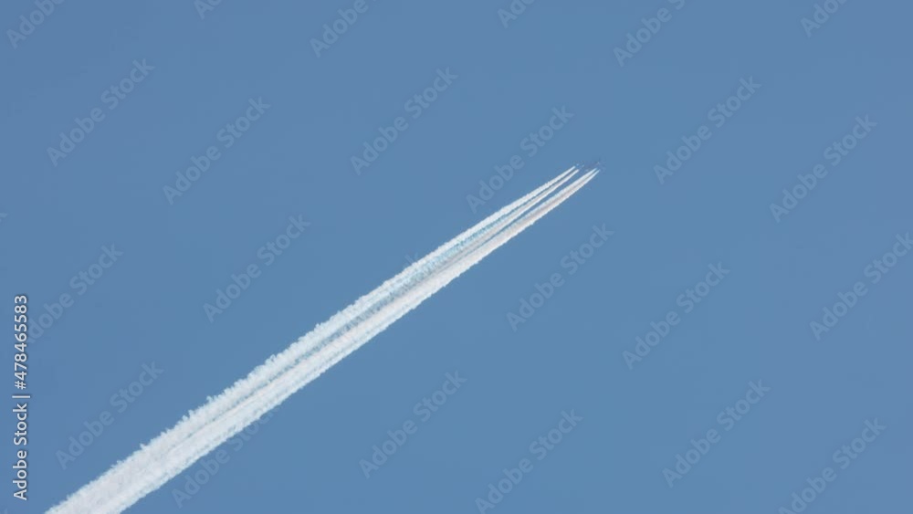 plane in the blue sky leaving a mark behind . plane in the blue sky leaving a mark behind .