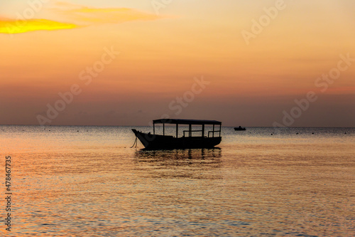 Wooden boat in the Indian ocean at sunset on Zanzibar, Tanzania