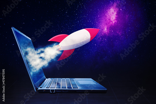 Rocket flying out from a laptop screen photo
