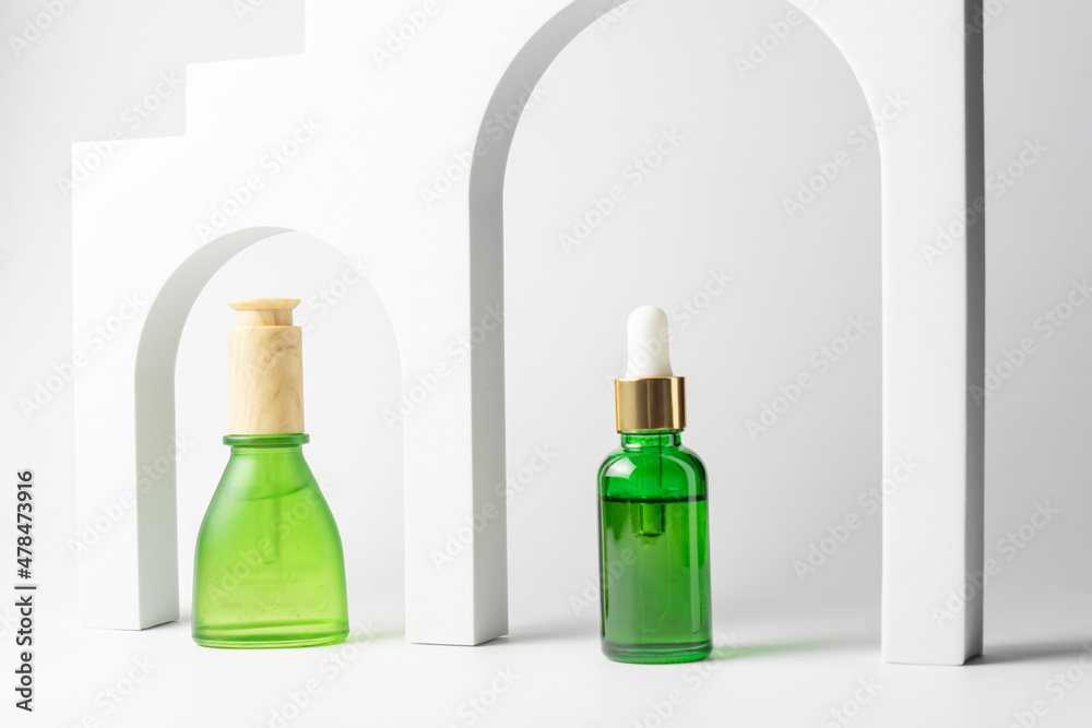 Set of beauty cosmetic products in green glass. Natural beauty oil for skin care with peptides for healthy and bright skin. Set of beauty cosmetic products in green glass. Natural beauty oil for skin care with peptides for healthy and bright skin.