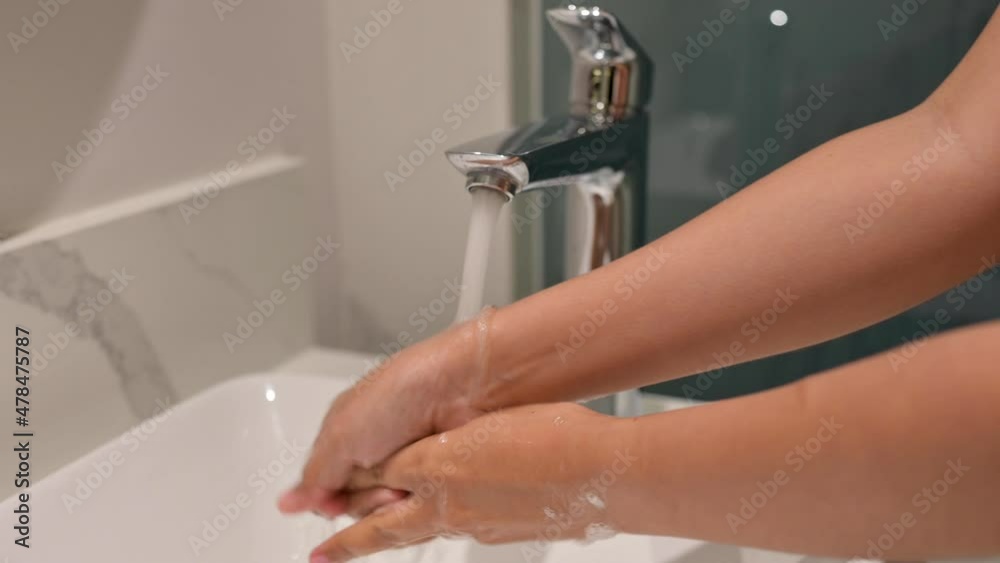 4K hand of woman wash hands at the wash basin with foam, woman washing male hand with soap and water under faucet in hotel room during travel.Health and beauty concepts,Travel concept 4K hand of woman wash hands at the wash basin with foam, woman washing male hand with soap and water under faucet in hotel room during travel.Health and beauty concepts,Travel concept