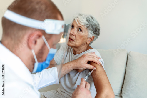 Wallpaper Mural Cropped shot of a young doctor giving a senior woman a vaccination. Virus protection. Doctor giving injection to patient at home, close up. Vaccination day. Healthcare and medicine concept. Torontodigital.ca