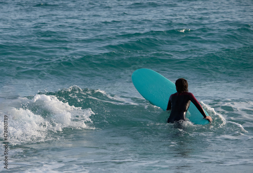 Fotografi girl or woman practicing surf sport on winter season in the Poetto beach in Cagliari - Sardinia