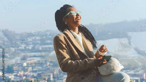 young elegnt girl elegantly dressed in winter outfit in front of  mountain scenery background photo