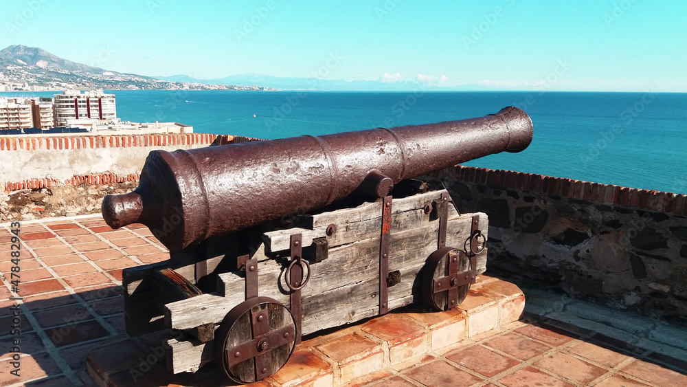 cast iron cannon aimed at the sea. country defense concept. illustration of medieval travel