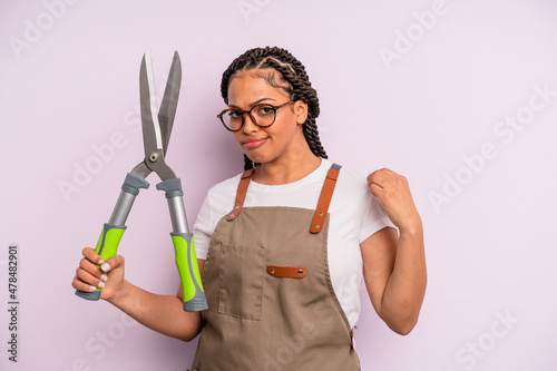 black afro woman looking arrogant, successful, positive and proud. gardenner or farmer concept photo