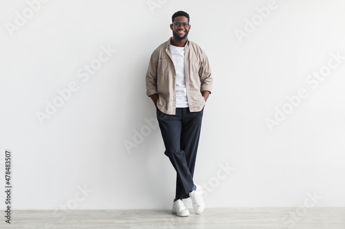 Obraz na plátně Handsome young black man in casual wear looking at camera and smiling, standing