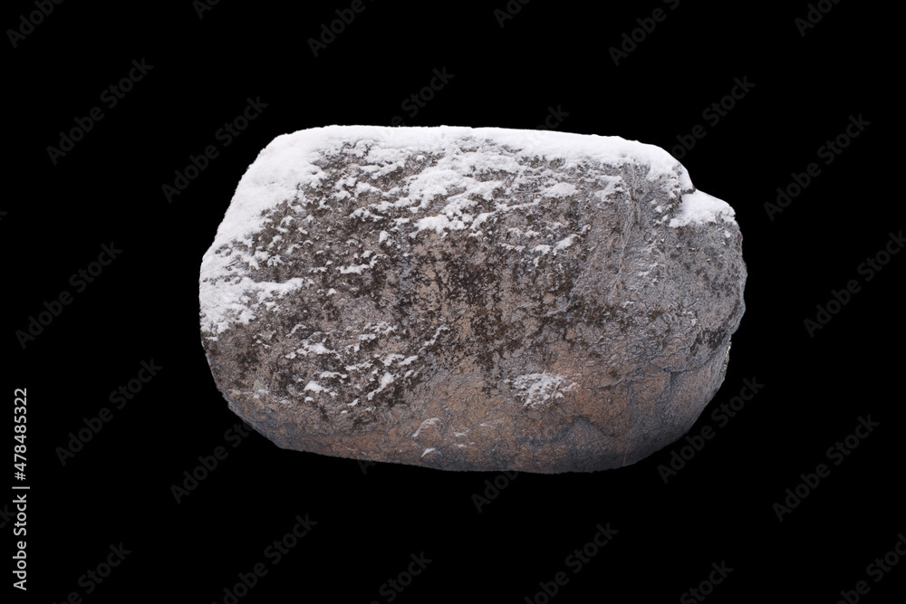 stone in the snow isolated on a black background stone in the snow isolated on a black background