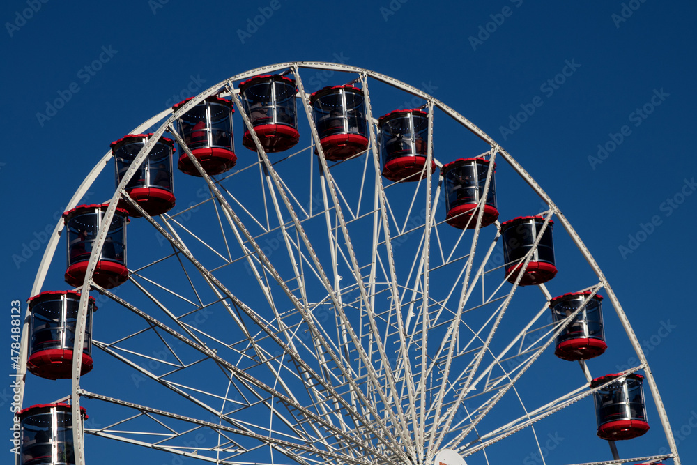 Ferris Wheel at a Fairground Against a Clear Blue Autumn Sky