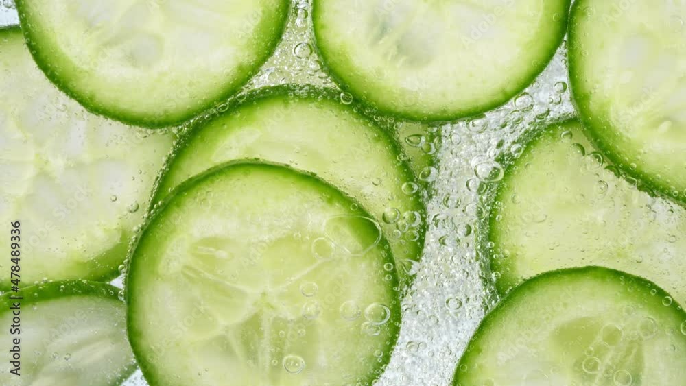 Slices of Cucumber in Water with Bubbles, Home Made Lemonade. Super Slow Motion, Filmed on High Speed Cinematic Camera at 1000 fps. Slices of Cucumber in Water with Bubbles, Home Made Lemonade. Super Slow Motion, Filmed on High Speed Cinematic Camera at 1000 fps.