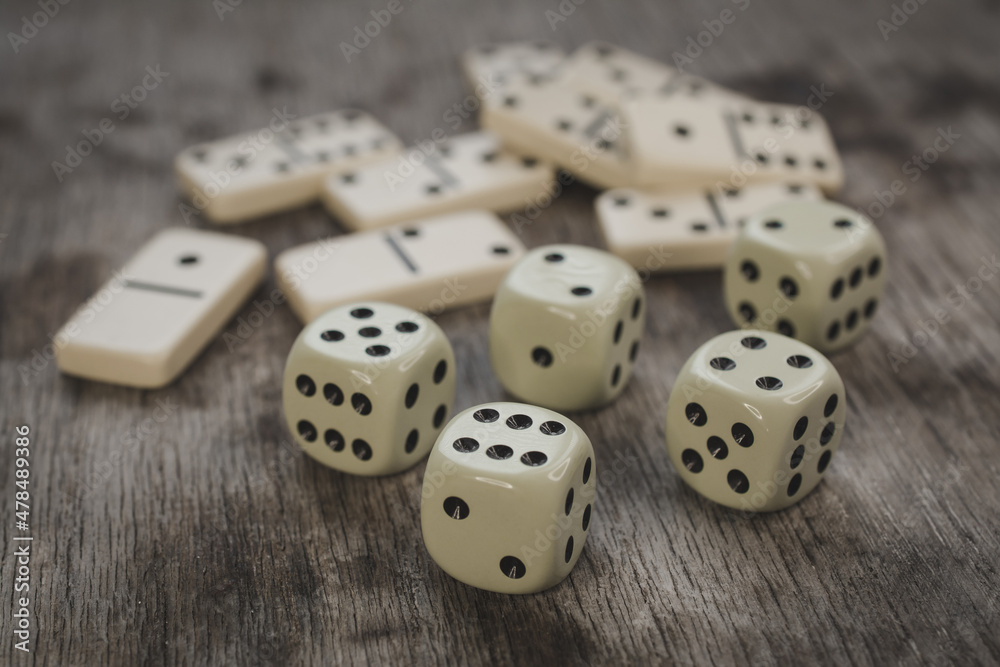 Dice and dominoes on wooden table, casino luck Dice and dominoes on wooden table, casino luck
