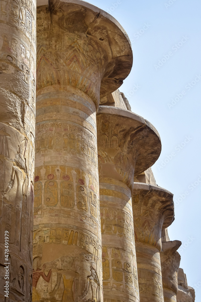 Columns of Karnak Temple complex with carved ancient Egyptian hieroglyphs and symbols. Great hypostyle hall in temples of Karnak (ancient Thebes). Luxor, Egypt
