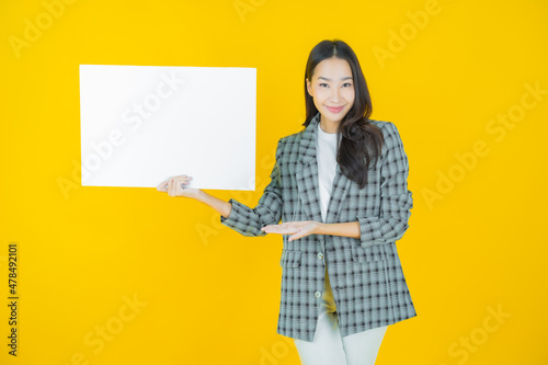 Portrait beautiful young asian woman with empty white billboard