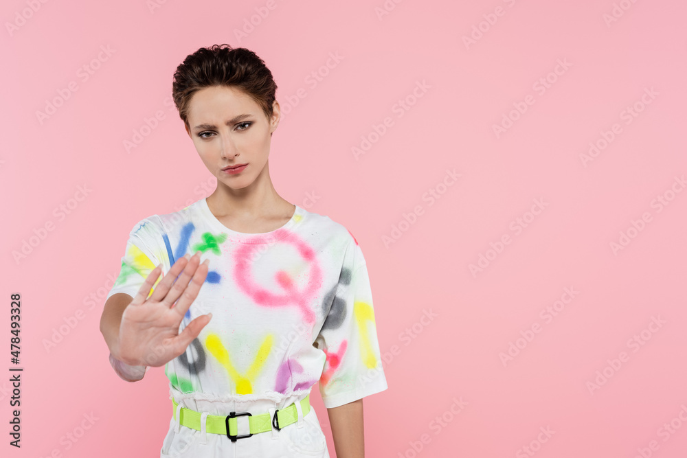 frustrated woman showing stop sign while looking at camera isolated on pink frustrated woman showing stop sign while looking at camera isolated on pink