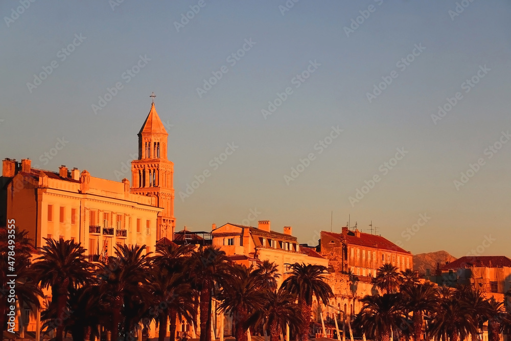 Saint Domnius bell tower and historical buildings on promenade in Split, Croatia, illuminated by beautiful golden hour light. 