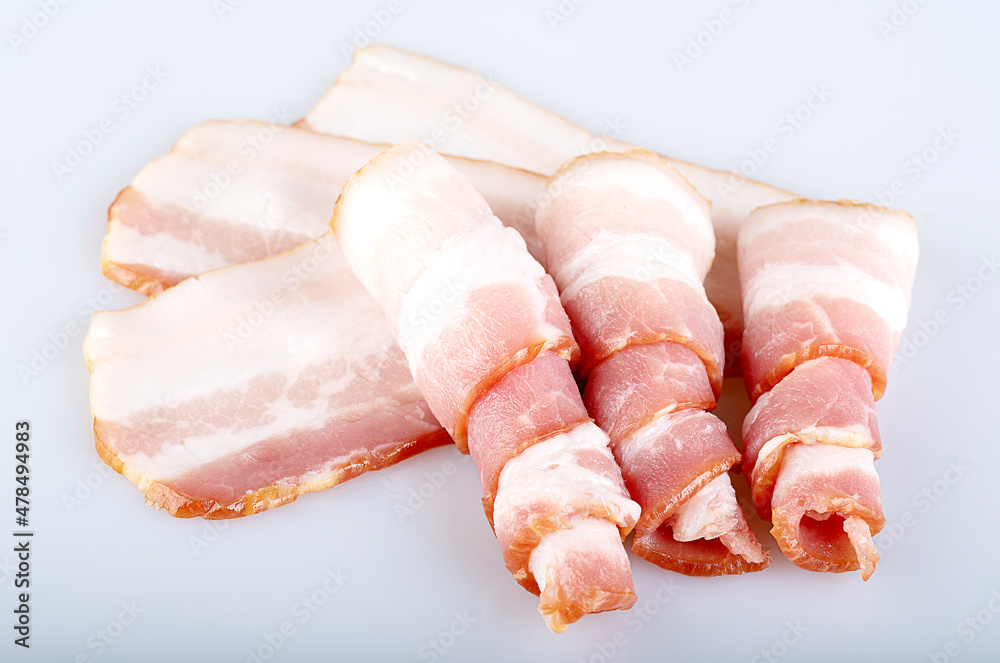 Raw bacon rolls isolated on a white background. top view Raw bacon rolls isolated on a white background. top view