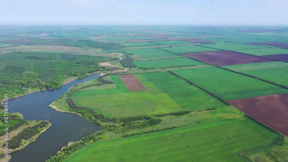 A body of water among spring agricultural fields and trees. Aerial view A body of water among spring agricultural fields and trees. Aerial view