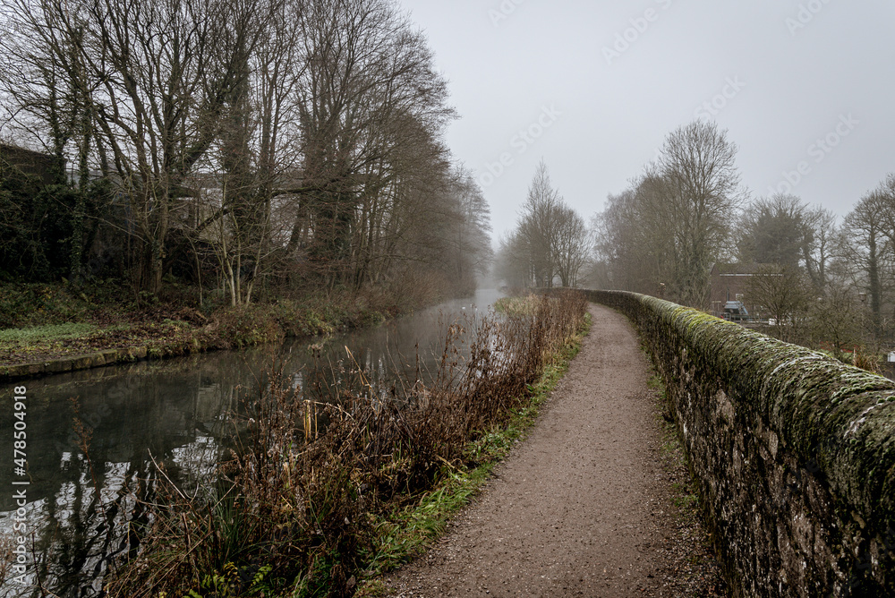 canal in the countryside with fog