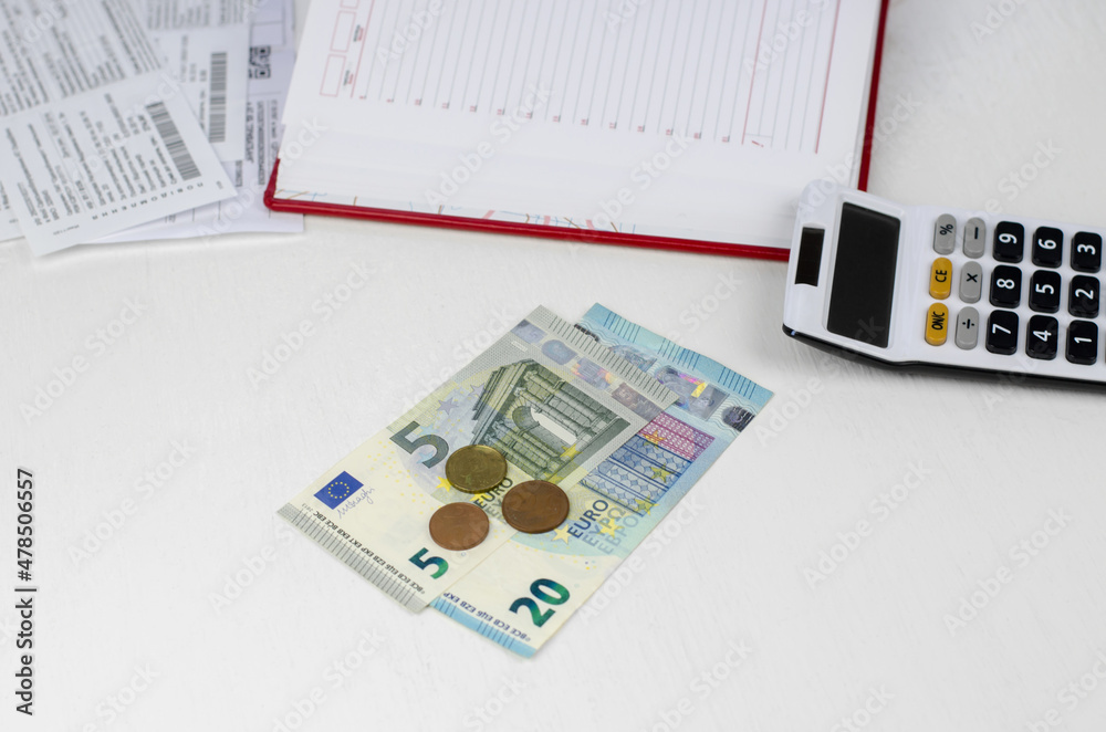 Fototapeta premium Euro money and calculator on a white table.